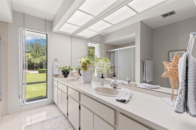 440 Lakeview Dr Unit 34, Palm Harbor, FL 34683 - bathroom featuring double vanity, a shower stall, healthy amount of natural light, and tile patterned flooring