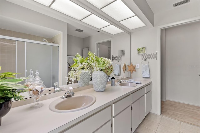 440 Lakeview Dr Unit 34, Palm Harbor, FL 34683 - bathroom featuring double vanity, a shower stall, and tile patterned floors