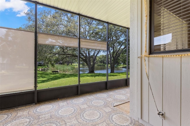 440 Lakeview Dr Unit 34, Palm Harbor, FL 34683 - unfurnished sunroom featuring a water view, healthy amount of natural light, and view of scattered trees