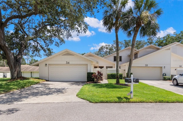 440 Lakeview Dr Unit 34, Palm Harbor, FL 34683 - view of front of home featuring an attached garage, concrete driveway, and a front yard