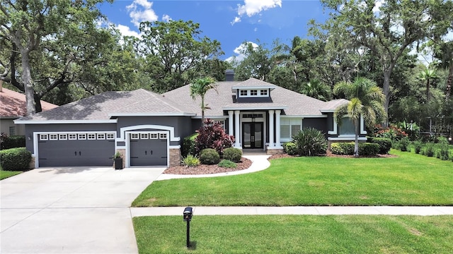 15024 Eaglepark Pl, Lithia, FL 33547 - view of front of home with a garage, concrete driveway, a front lawn, and a shingled roof