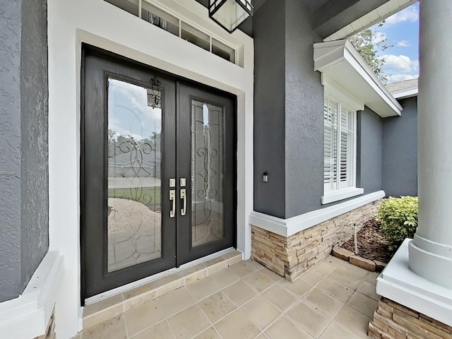 15024 Eaglepark Pl, Lithia, FL 33547 - view of exterior entry featuring stucco siding and french doors