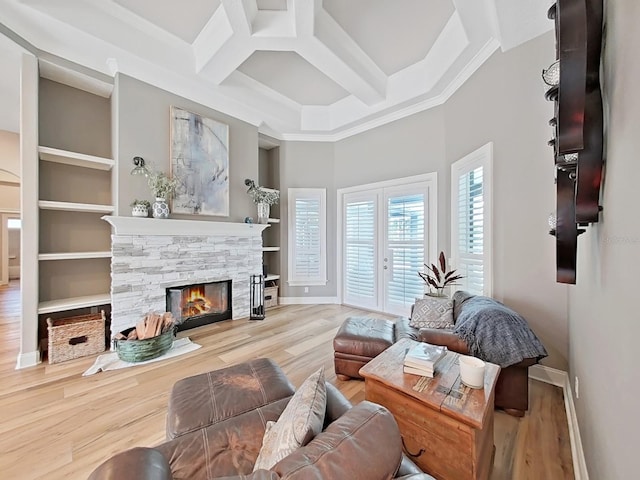 15024 Eaglepark Pl, Lithia, FL 33547 - living room featuring coffered ceiling, a stone fireplace, wood finished floors, beamed ceiling, and a towering ceiling