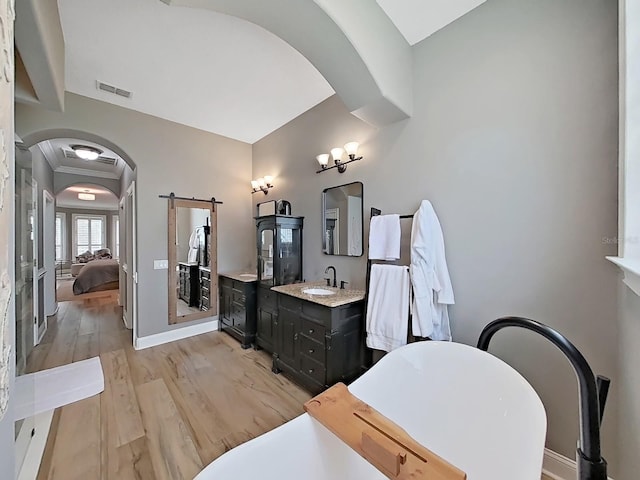 15024 Eaglepark Pl, Lithia, FL 33547 - ensuite bathroom featuring a freestanding tub, vanity, and wood finished floors