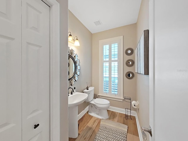 15024 Eaglepark Pl, Lithia, FL 33547 - bathroom with toilet and wood finished floors