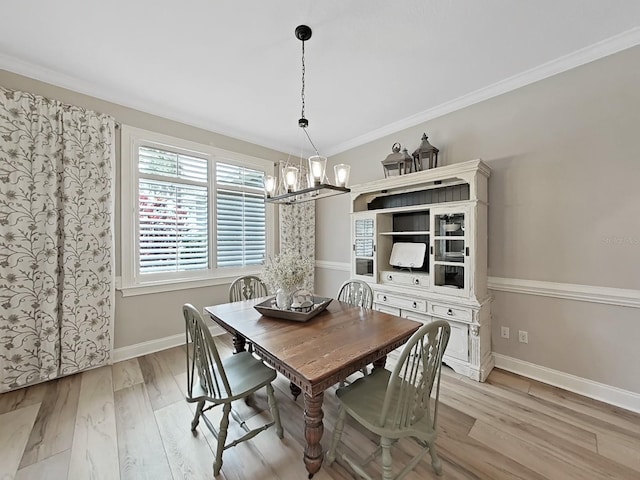 15024 Eaglepark Pl, Lithia, FL 33547 - dining area with a chandelier, light wood finished floors, plenty of natural light, and crown molding