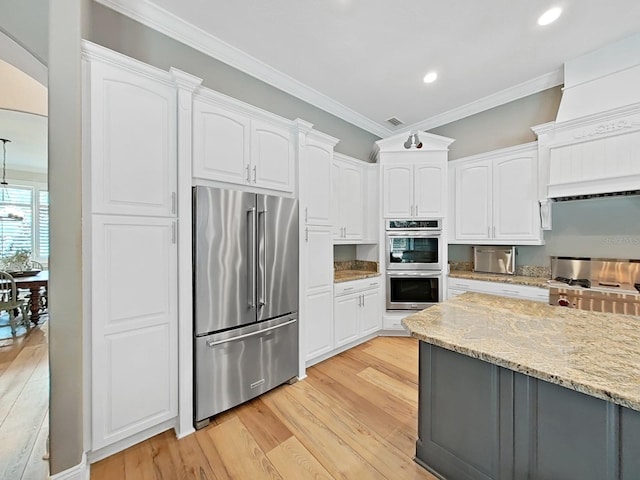 15024 Eaglepark Pl, Lithia, FL 33547 - kitchen with appliances with stainless steel finishes, crown molding, light wood-type flooring, white cabinets, and light stone countertops