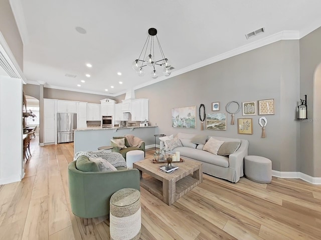 15024 Eaglepark Pl, Lithia, FL 33547 - living area with crown molding, recessed lighting, light wood finished floors, and a chandelier