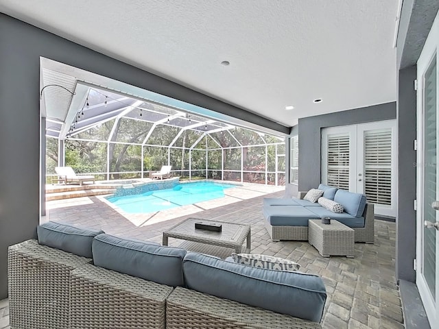 15024 Eaglepark Pl, Lithia, FL 33547 - view of swimming pool with an outdoor hangout area, a pool with connected hot tub, a patio, french doors, and a lanai