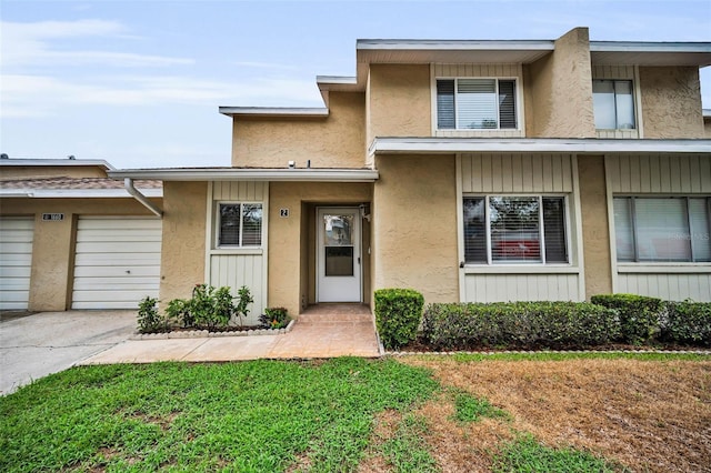 1660 Cape Ann Ave NE Unit 2, Saint Petersburg, FL 33702 - multi unit property with driveway, stucco siding, and an attached garage