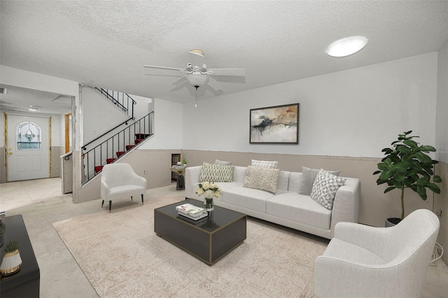 1660 Cape Ann Ave NE Unit 2, Saint Petersburg, FL 33702 - living room with stairs, a ceiling fan, and a textured ceiling