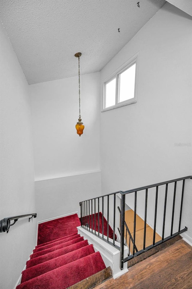 1660 Cape Ann Ave NE Unit 2, Saint Petersburg, FL 33702 - stairway with wood finished floors and a textured ceiling