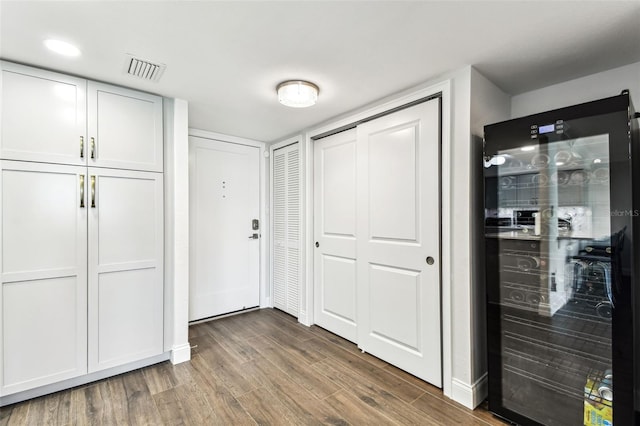 400 Island Way Unit 502, Clearwater Beach, FL 33767 - corridor featuring wine cooler and wood finished floors