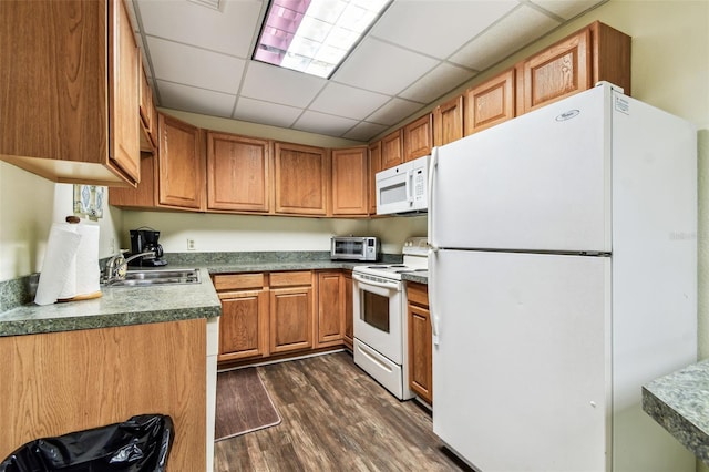 400 Island Way Unit 502, Clearwater Beach, FL 33767 - kitchen featuring white appliances, dark wood-type flooring, brown cabinets, dark countertops, and a drop ceiling