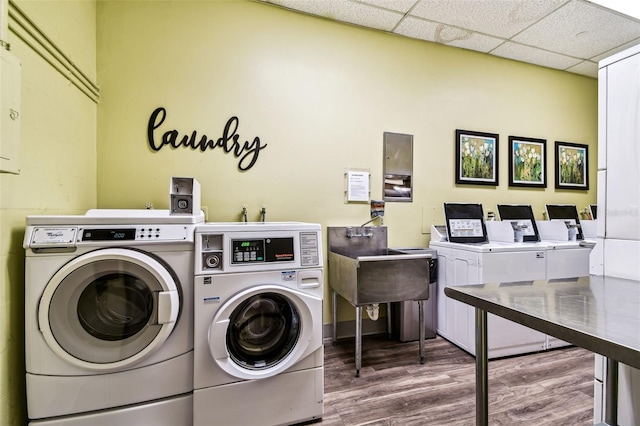 400 Island Way Unit 502, Clearwater Beach, FL 33767 - community laundry room featuring washing machine and dryer, wood finished floors, and an office area