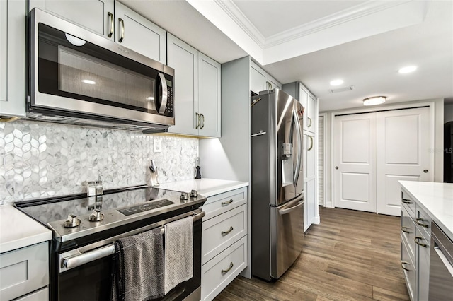 400 Island Way Unit 502, Clearwater Beach, FL 33767 - kitchen featuring appliances with stainless steel finishes, ornamental molding, light countertops, dark wood finished floors, and gray cabinetry