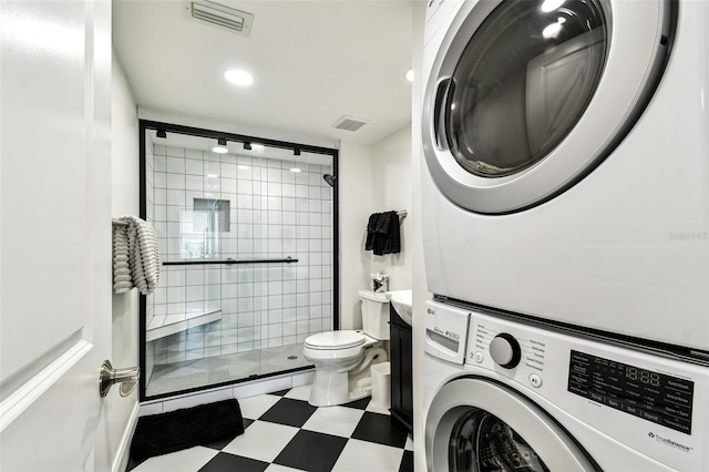 400 Island Way Unit 502, Clearwater Beach, FL 33767 - full bath with stacked washer and clothes dryer, a stall shower, recessed lighting, and tile patterned floors