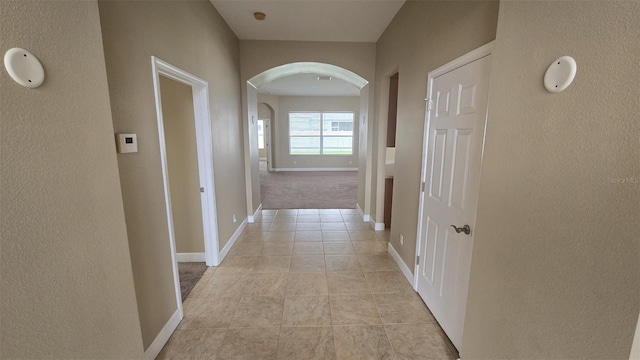 11341 Durham St, Parrish, FL 34219 - hallway featuring arched walkways, light tile patterned floors, and a textured wall