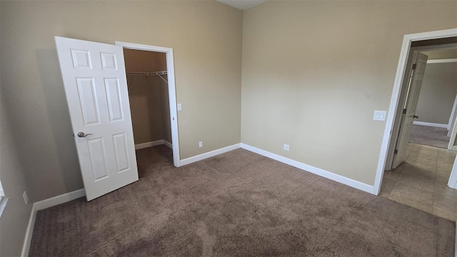 11341 Durham St, Parrish, FL 34219 - unfurnished bedroom featuring carpet, a walk in closet, and a closet