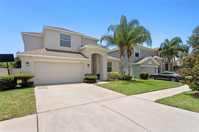 10216 Summer Azure Dr, Riverview, FL 33578 - view of front of home featuring concrete driveway, a front yard, stucco siding, and a garage