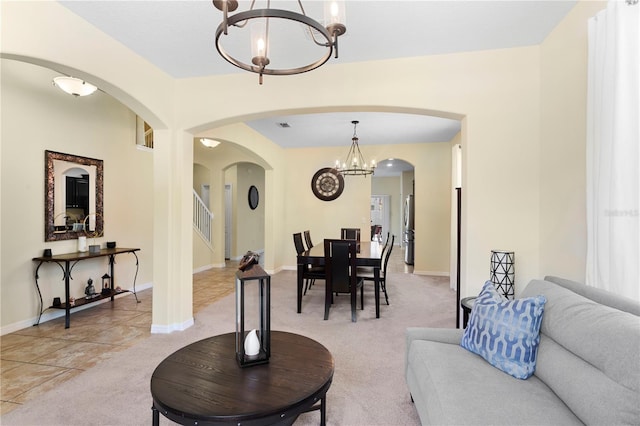 10216 Summer Azure Dr, Riverview, FL 33578 - dining space with a chandelier, arched walkways, stairway, and light carpet