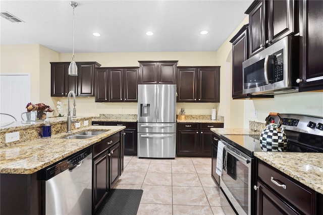 10216 Summer Azure Dr, Riverview, FL 33578 - kitchen featuring appliances with stainless steel finishes, light stone countertops, recessed lighting, light tile patterned flooring, and hanging light fixtures
