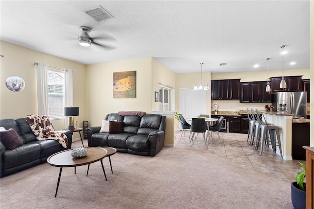10216 Summer Azure Dr, Riverview, FL 33578 - living room featuring ceiling fan, a chandelier, a textured ceiling, light colored carpet, and recessed lighting