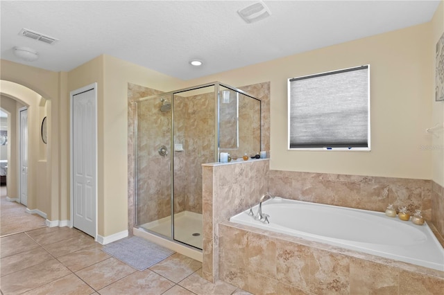 10216 Summer Azure Dr, Riverview, FL 33578 - bathroom with a bath, a shower stall, and tile patterned flooring