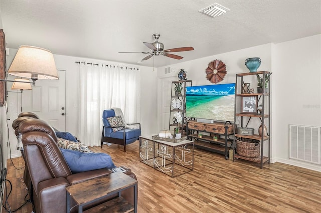 630 Mac Crillus Rd, Largo, FL 33770 - living room featuring wood finished floors, a ceiling fan, and a textured ceiling