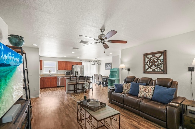 630 Mac Crillus Rd, Largo, FL 33770 - living area featuring a ceiling fan, dark wood-style floors, and a textured ceiling