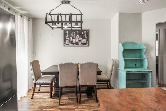 630 Mac Crillus Rd, Largo, FL 33770 - dining space with wood finished floors and a chandelier