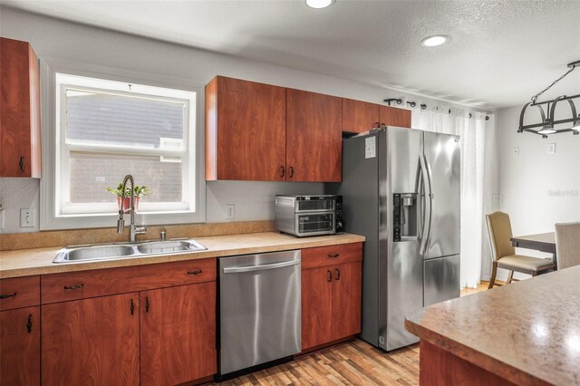 630 Mac Crillus Rd, Largo, FL 33770 - kitchen with appliances with stainless steel finishes, light countertops, light wood-type flooring, recessed lighting, and a textured ceiling