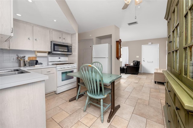 12400 Park Blvd Unit 417, Seminole, FL 33772 - kitchen with white appliances, tasteful backsplash, light countertops, ceiling fan, and recessed lighting