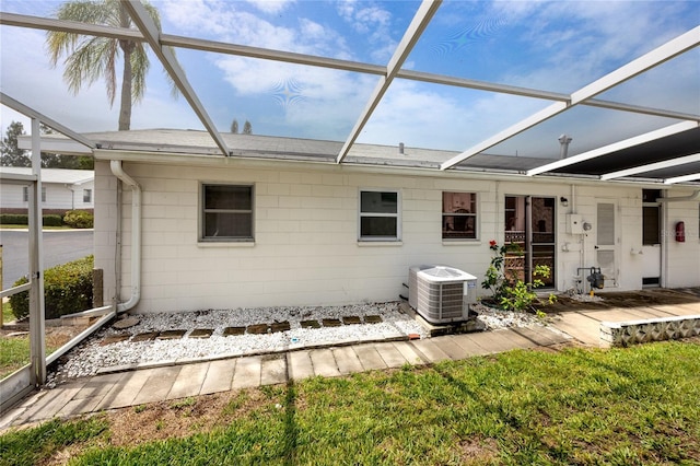 12400 Park Blvd Unit 417, Seminole, FL 33772 - rear view of house featuring glass enclosure and concrete block siding