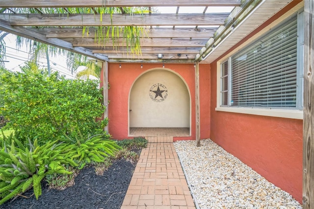 51 Cypress Dr, Palm Harbor, FL 34684 - property entrance with stucco siding and a pergola