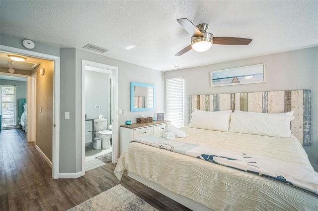 51 Cypress Dr, Palm Harbor, FL 34684 - bedroom with wood finished floors, a textured ceiling, ensuite bathroom, and ceiling fan