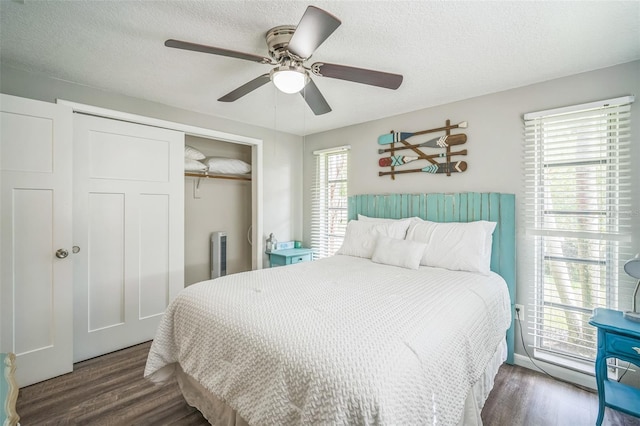 51 Cypress Dr, Palm Harbor, FL 34684 - bedroom with a closet, wood finished floors, ceiling fan, and a textured ceiling