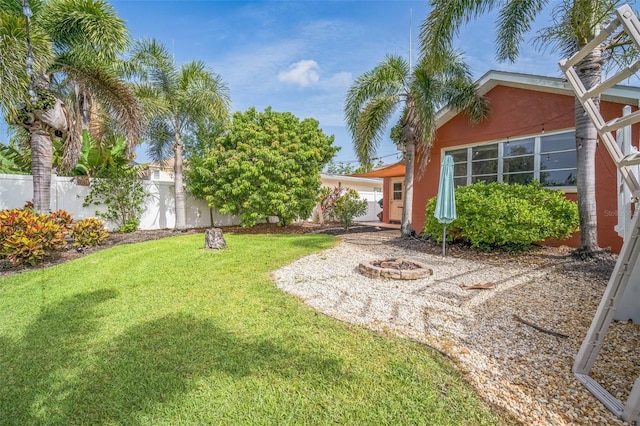 51 Cypress Dr, Palm Harbor, FL 34684 - view of yard featuring an outdoor fire pit