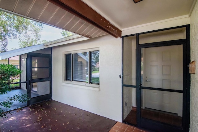 8626 Woodbridge Dr, New Port Richey, FL 34655 - view of exterior entry with stucco siding and a patio area
