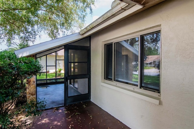 8626 Woodbridge Dr, New Port Richey, FL 34655 - view of exterior entry with stucco siding