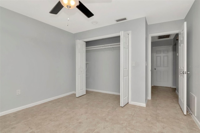 8626 Woodbridge Dr, New Port Richey, FL 34655 - unfurnished bedroom with a closet, a ceiling fan, and light tile patterned floors