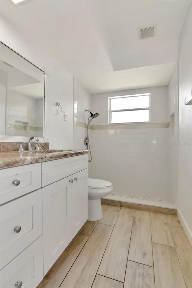 8626 Woodbridge Dr, New Port Richey, FL 34655 - bathroom featuring a walk in shower, vanity, and wood finished floors
