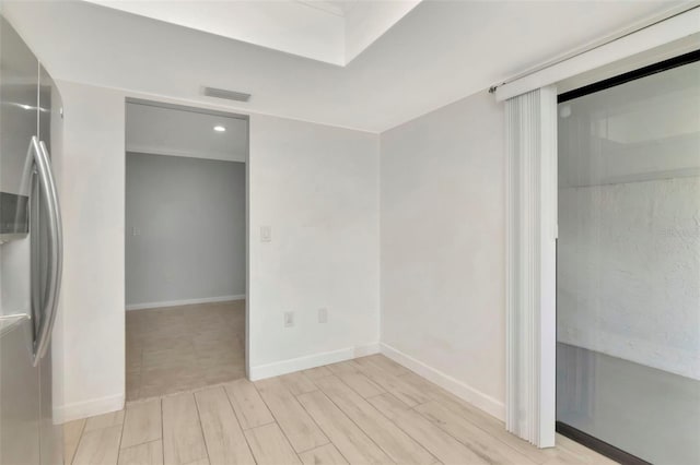 8626 Woodbridge Dr, New Port Richey, FL 34655 - unfurnished bedroom with freestanding refrigerator, wood finish floors, a closet, and recessed lighting