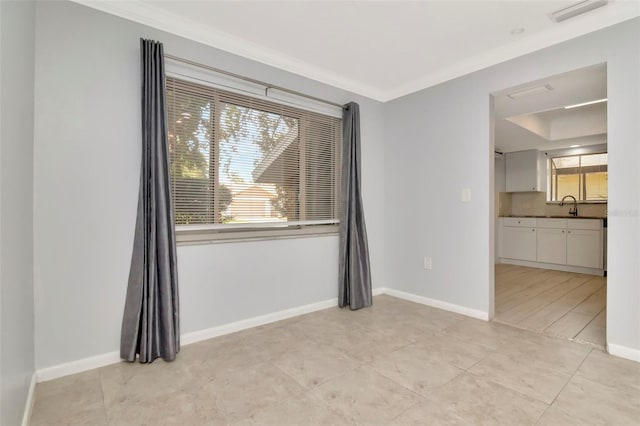 8626 Woodbridge Dr, New Port Richey, FL 34655 - spare room featuring ornamental molding and light tile patterned floors
