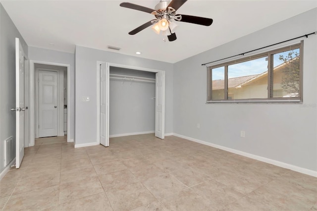 8626 Woodbridge Dr, New Port Richey, FL 34655 - unfurnished bedroom with a closet, ceiling fan, and light tile patterned floors
