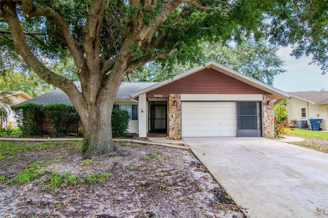 8626 Woodbridge Dr, New Port Richey, FL 34655 - single story home with an attached garage, stone siding, driveway, and a shingled roof