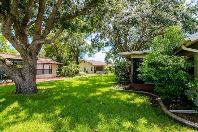 8626 Woodbridge Dr, New Port Richey, FL 34655 - view of green lawn with a sunroom