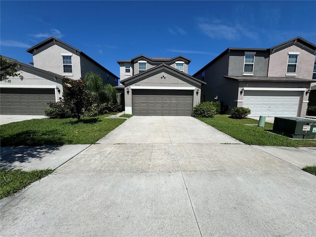 4448 Globe Thistle, Tampa, FL 33619 - traditional-style home with driveway, a garage, stucco siding, and a front lawn
