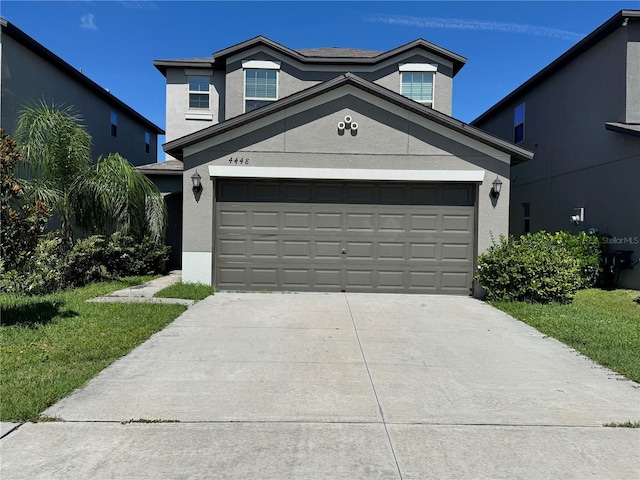 4448 Globe Thistle, Tampa, FL 33619 - view of front facade featuring driveway, stucco siding, and a garage