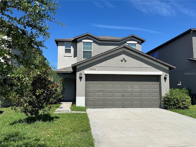 4448 Globe Thistle, Tampa, FL 33619 - view of front of house with stucco siding, driveway, and an attached garage
